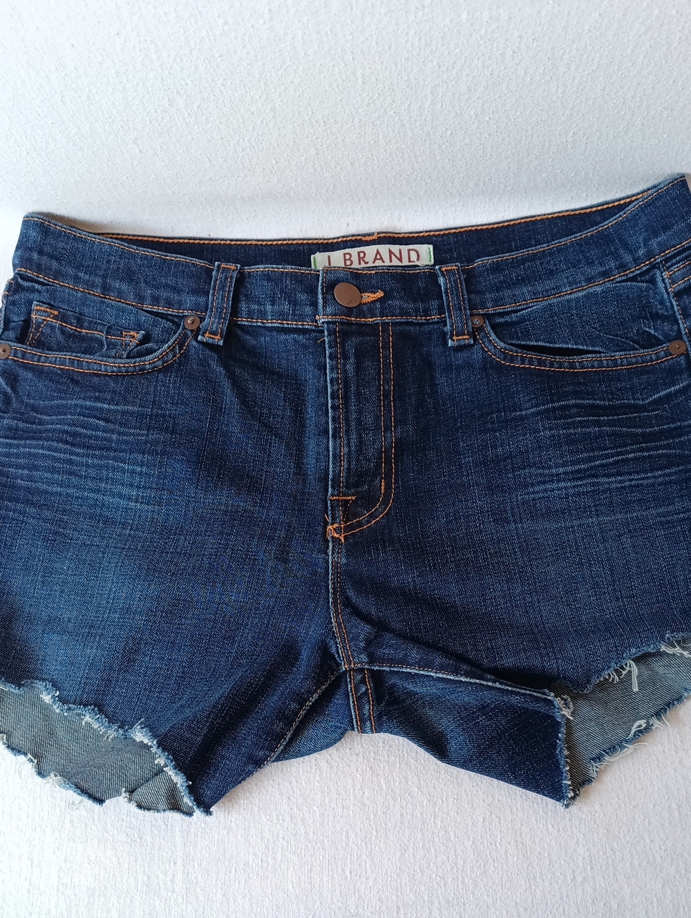 Indigo Distressed Denim Cutoff Shorts With Subtle Back Pocket Graphic
